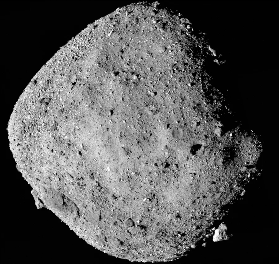 The rough, boulder-covered surface of asteroid Bennu against black space.