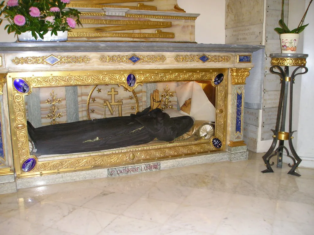 The vested reliquary display attributed to Catherine Labouré in the Chapel of the Miraculous Medal, Paris. Appearance alone cannot establish the material condition beneath the clothing or display surfaces.