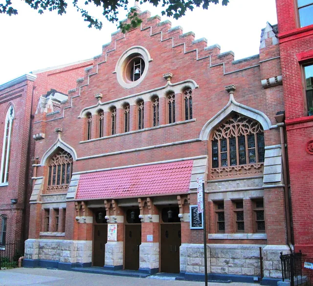 The red-brick Church of Saint Catherine of Genoa in Manhattan, with a stepped gable, Gothic windows and a sheltered entrance.