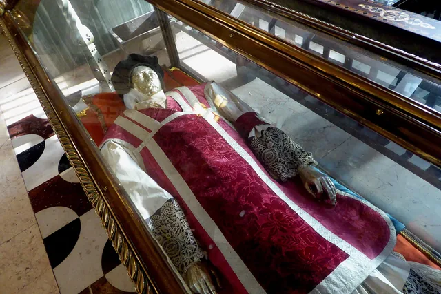 John Southworth’s vested reliquary display in Westminster Cathedral. The visible metallic face covering and vested form should not be read as an untreated intact body.