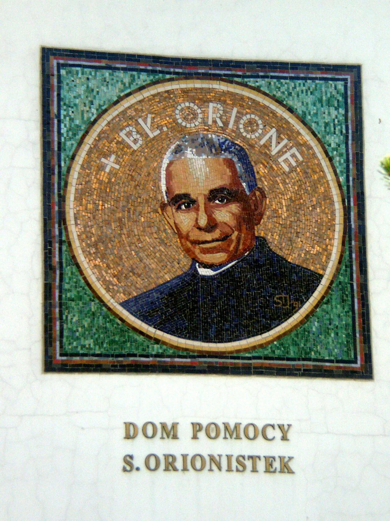 An exterior mosaic portrait of Luigi Orione holding a cross at the Orionist Sisters’ home in Koło, Poland.