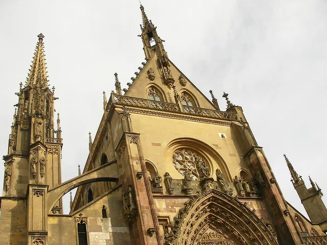 The Gothic west front and openwork spire of the collegiate church of Saint-Thiébaut in Thann.