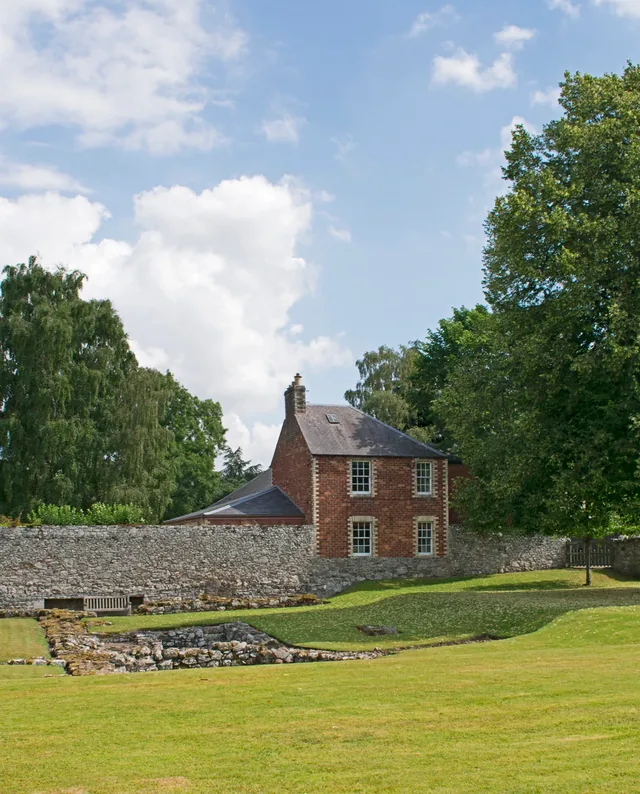 A building along the eastern wall of Melrose Abbey, viewed from the Commendator's House grounds in 2022.